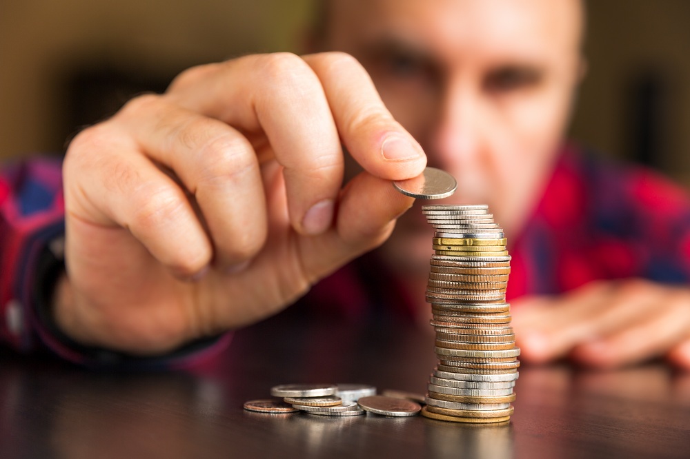 Man stacking coins