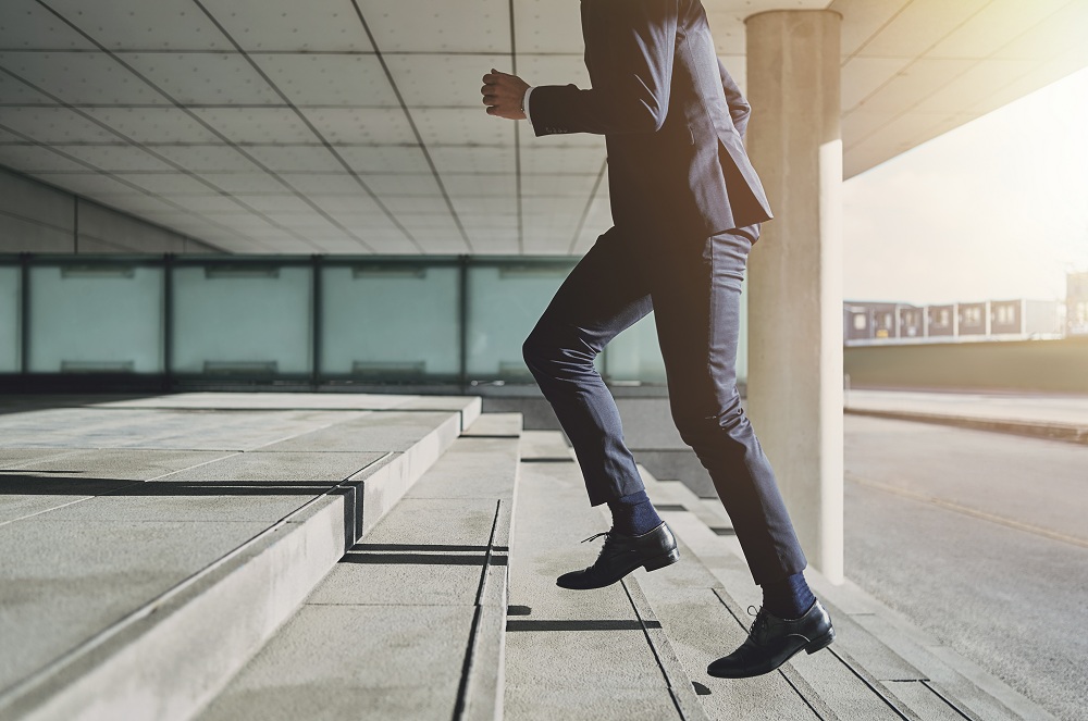 Man climbing the stairs of success