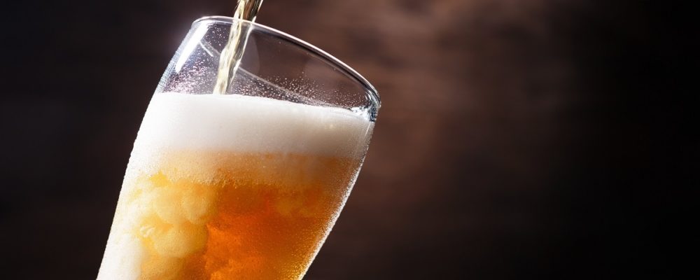 Pouring beer on a glass