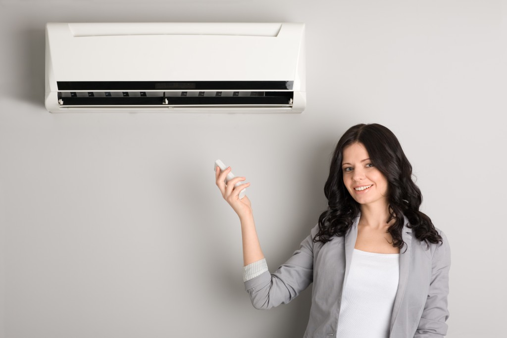 woman satisfied with her air conditioner