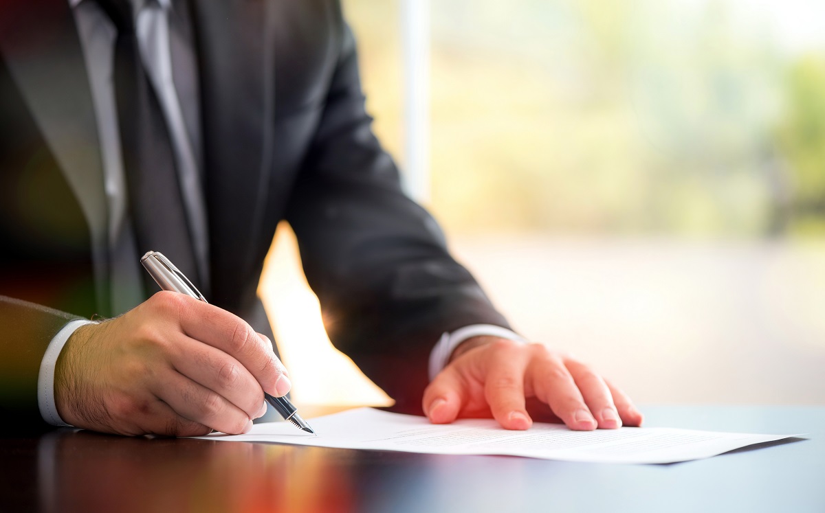 Man signing with a pen