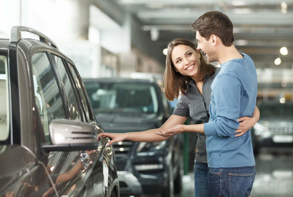 Couple looking at a new car