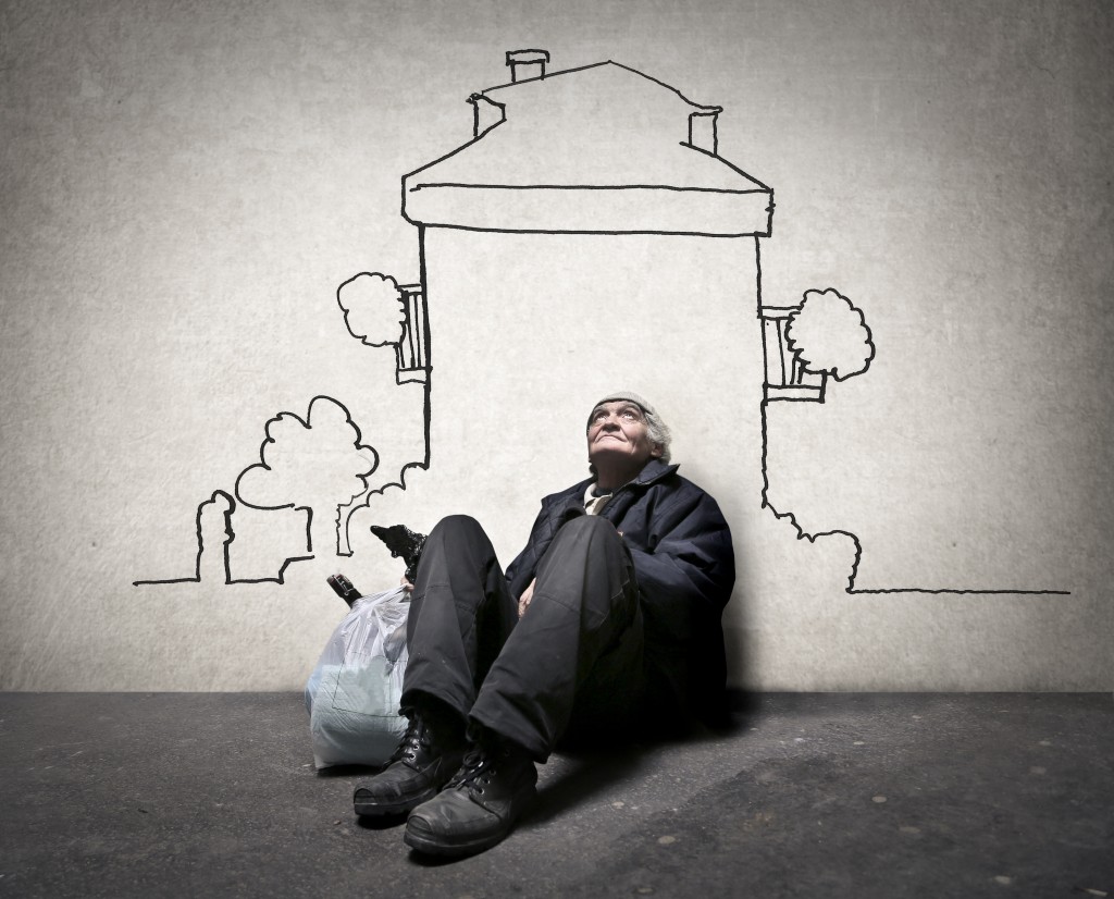 man sitting in front of a mural