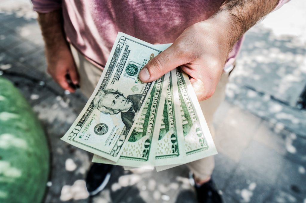 person holding cash