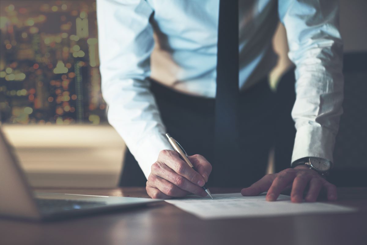 businessman writing on paper