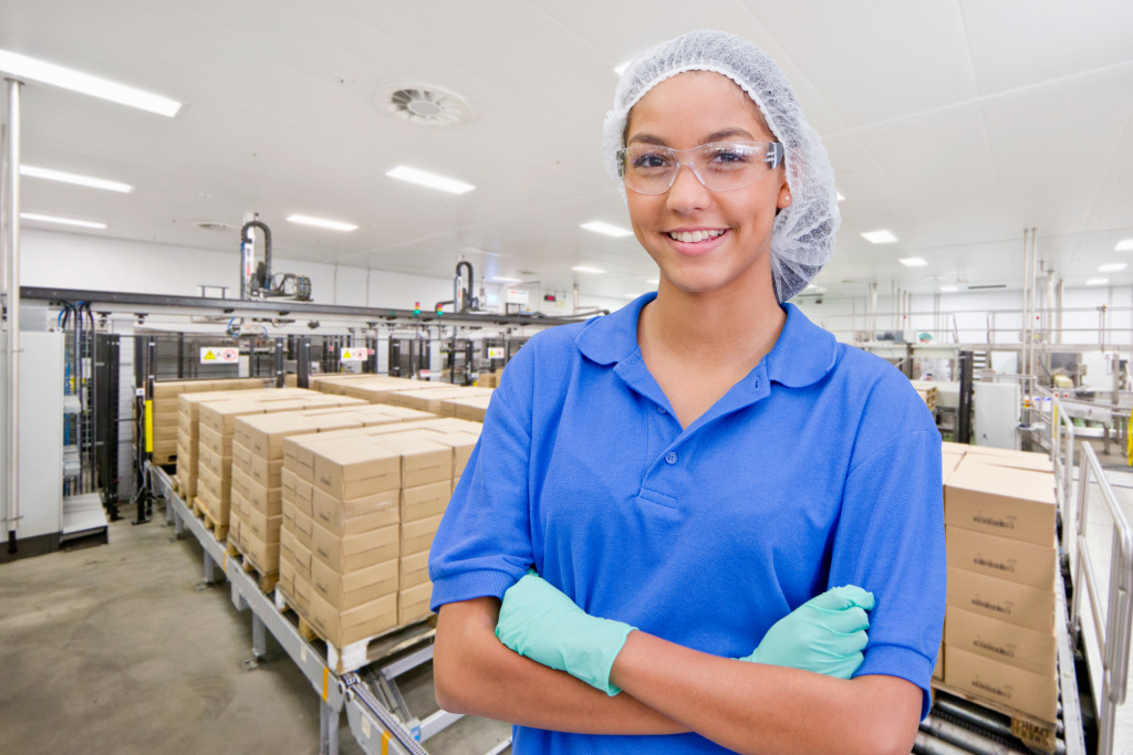 A smiling woman worker in a food packaging line